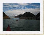 Alaska 547 * Robert paddles closer to the South Sawyer Glacier.  The bands of scoured, light colored cliff faces clearly show the location of the glacier in recent times.   * Robert paddles closer to the South Sawyer Glacier.  The bands of scoured, light colored cliff faces clearly show the location of the glacier in recent times.   * 1600 x 1200 * (506KB)